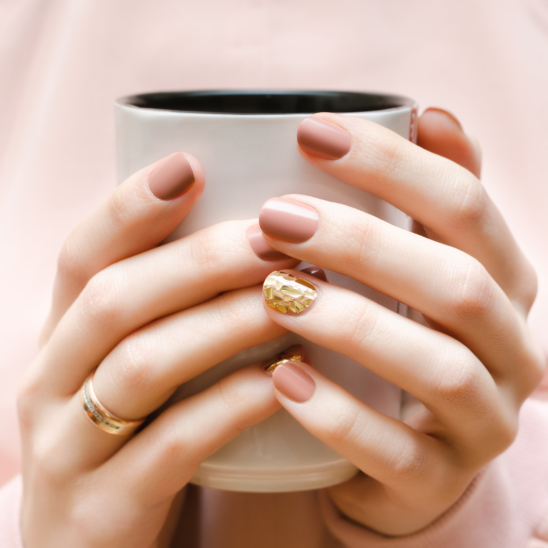 a woman with numb painful hands holds a cup, she has arthritis and has been recommended to try compression gloves 