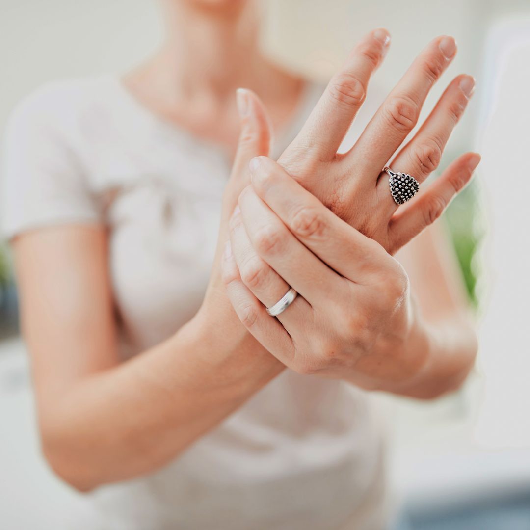 Woman holding her hands and pressing her thumb with her fingers, she has cmc osteoarthritis or thumb arthritis or basal arthritis, it is hand pain and thumb pain