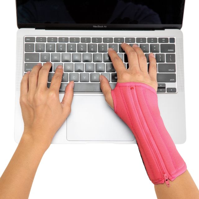 A hand wearing Bubblegum Pink Breathe Wrist Brace as demonstration when worn.