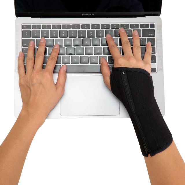 A hand wearing Classic Black Breathe Wrist Brace as demonstration when worn