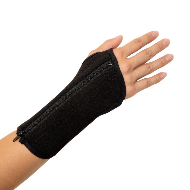 A hand wearing a classic black wrist brace with a zipper and adjustable straps, designed to reduce strain on the joint and muscles, alleviate pain and swelling, and keep the wrist in a neutral position for optimal comfort.