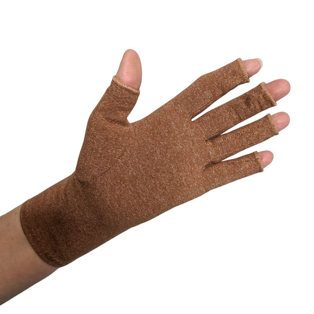 A close up of the hand of a woman with arthritis, wearing Heather Brown Compression Gloves and showing the back of her hand.