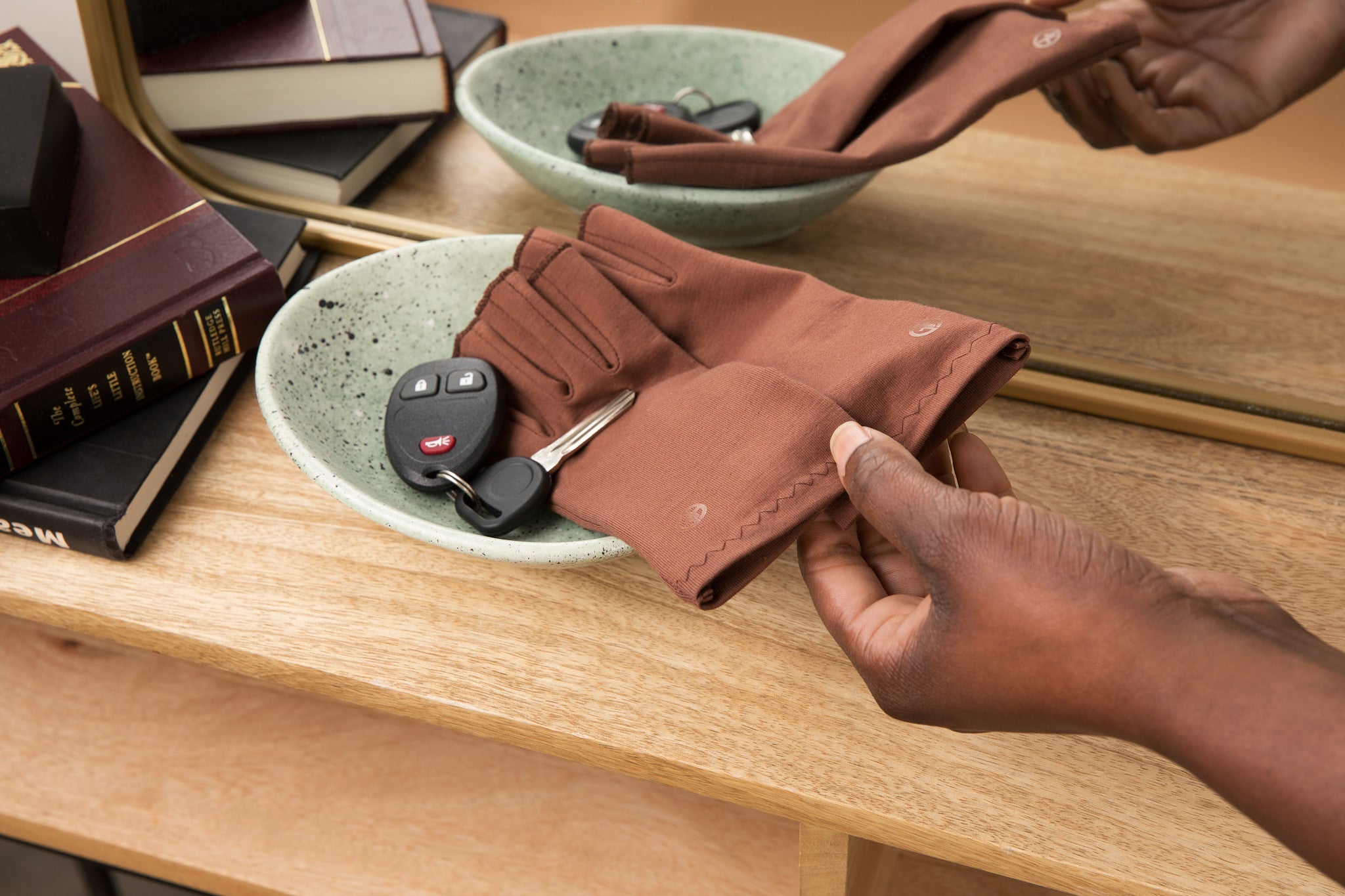 Cocoa Brown Compression Gloves laid together with keys held by a woman's hand